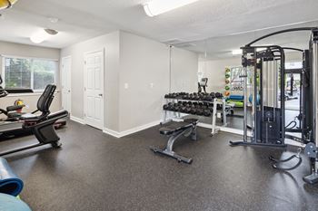 A spacious home gym with a variety of equipment.